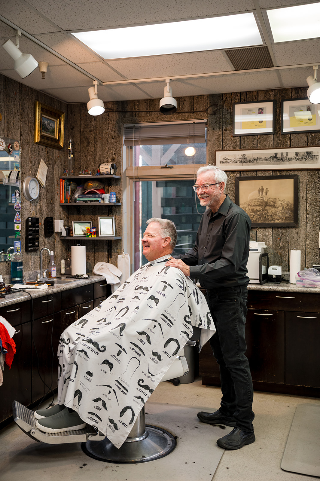 Barber and client sharing a laugh after a haircut